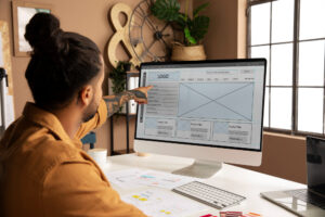 A man analyzing a diagram on his computer screen, demonstrating concentration and productivity in his work